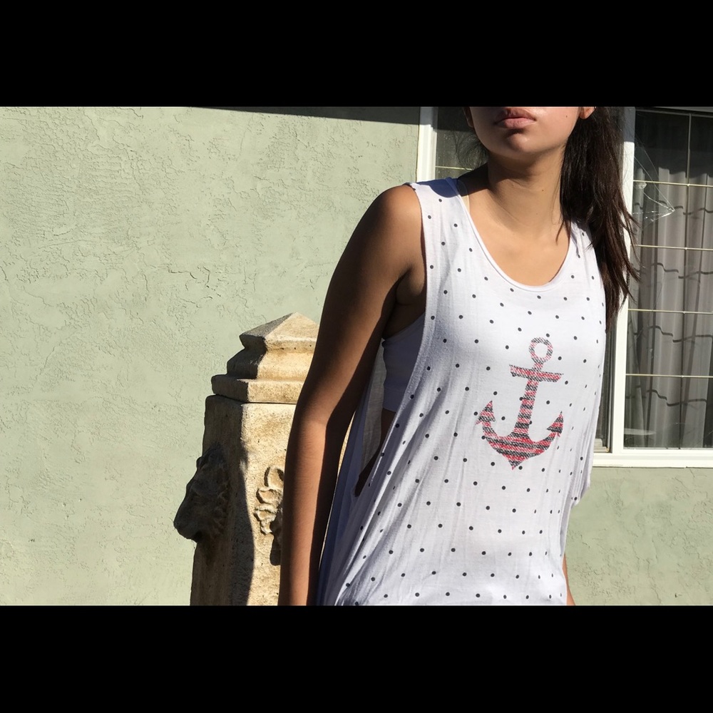 White muscle tee with a red anchor print.